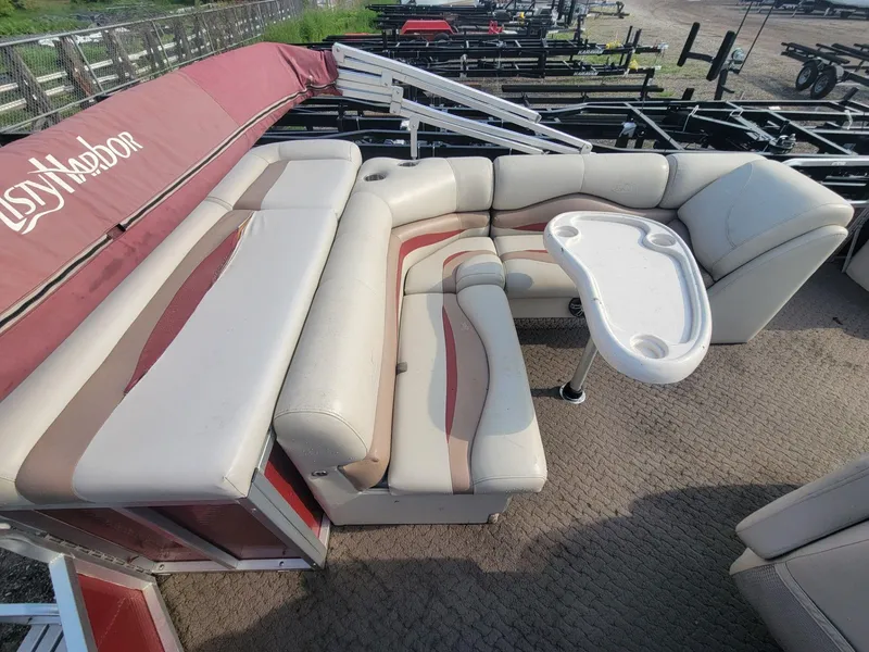 Slide: The Image of 2011 Misty Harbor 2285 DR pontoon boat interior with seating and table. - 13