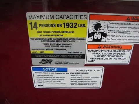 Slide: The Image of 2011 Misty Harbor 2285 DR capacity label, 14 persons or 1932 lbs, safety warnings included. - 14