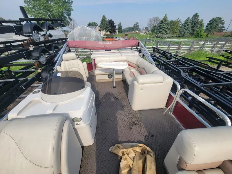 Slide: The Image of 2011 Misty Harbor 2285 DR pontoon boat with beige seating and red canopy. - 9