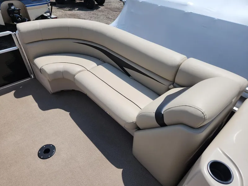 Slide: The Image of 2011 Harris FloteBote 200 Cruiser CX, beige seating, spacious deck, luxury pontoon boat interior. - 12
