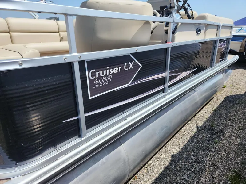 Slide: The Image of 2011 Harris FloteBote 200 Cruiser CX pontoon boat with beige seating and black paneling. - 6