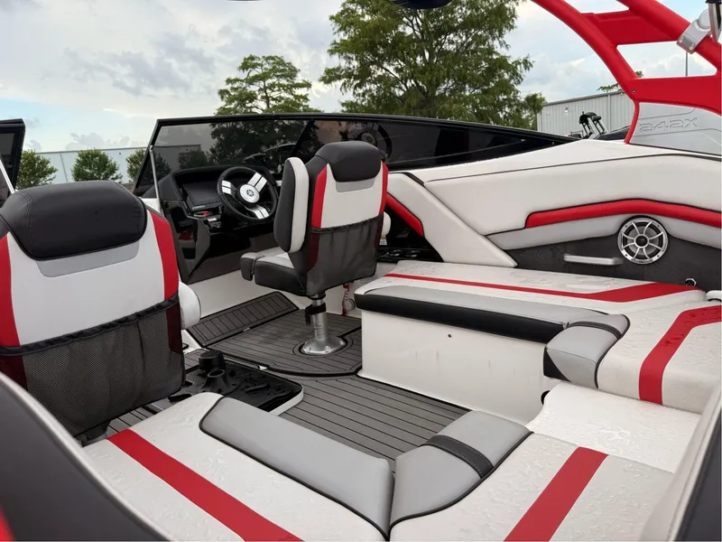 Slide: The Image of 2018 Yamaha Boats 242X E-Series interior with red and white seating, steering wheel, and dashboard. - 5