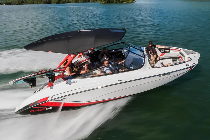 Slide: The Image of 2018 Yamaha Boats 242X E-Series speeding on water with passengers enjoying the ride. - 7