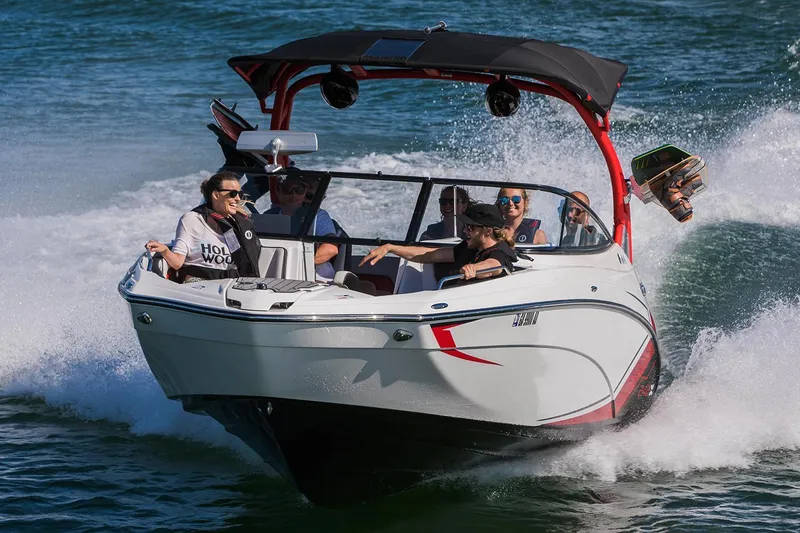 Slide: The Image of 2018 Yamaha Boats 242X E-Series cruising on water with passengers enjoying the ride. - 8