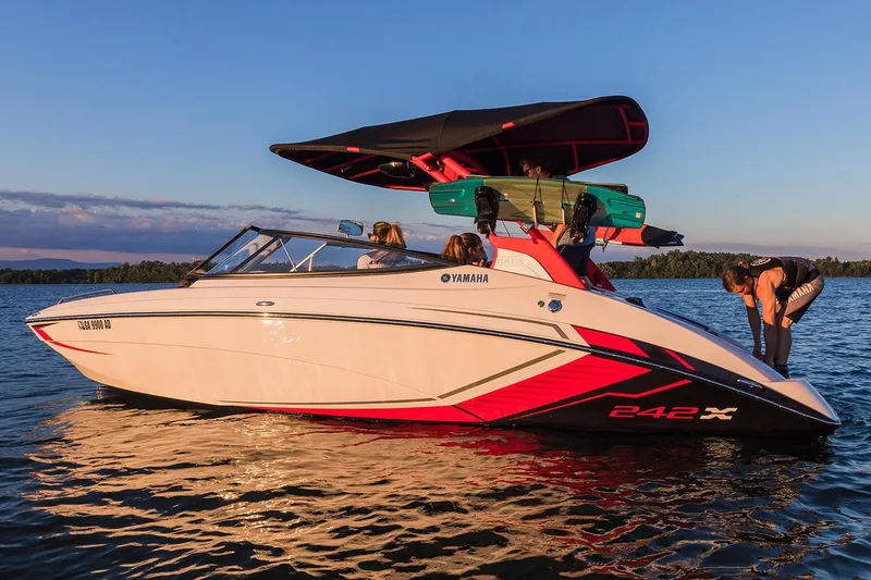 Slide: The Image of 2018 Yamaha Boats 242X E-Series on a serene lake at sunset. - 9