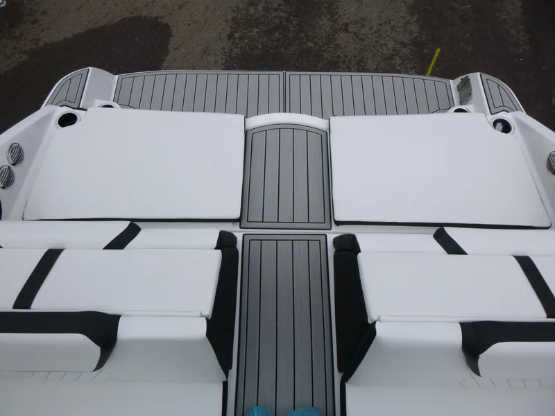 Slide: The Image of 2025 Yamaha Boats 222SD deck with white seating and gray flooring. - 12