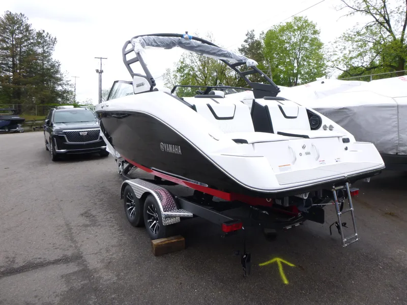 Slide: The Image of 2025 Yamaha Boats 222SD on trailer, parked outdoors, rear view. - 2