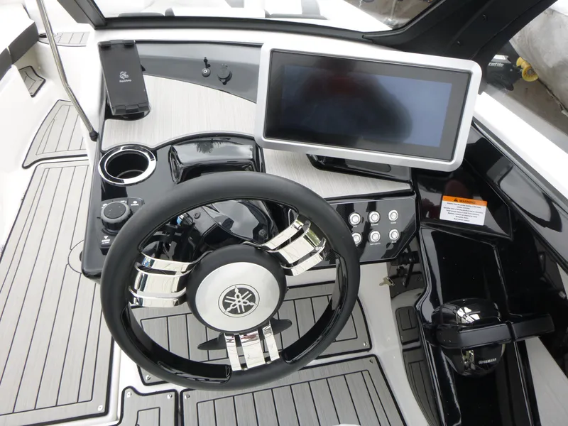 Slide: The Image of 2025 Yamaha Boats 222SD dashboard with steering wheel and touchscreen display. - 6