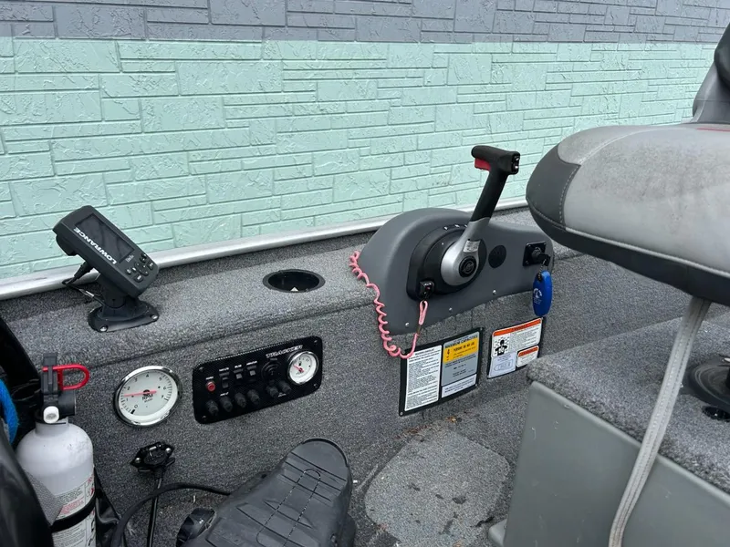 Slide: The Image of 2015 Bass Tracker Panfish 16 boat dashboard with controls and gauges. - 4