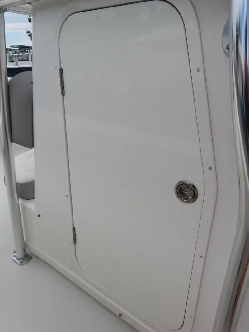 Slide: The Image of 2021 Parker 2300 Special Edition boat cabin door, white exterior, docked at marina. - 12