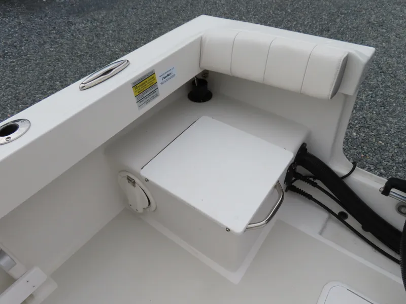 Slide: The Image of 2021 Parker 2300 Special Edition boat interior with storage compartment and cushioned seating. - 26