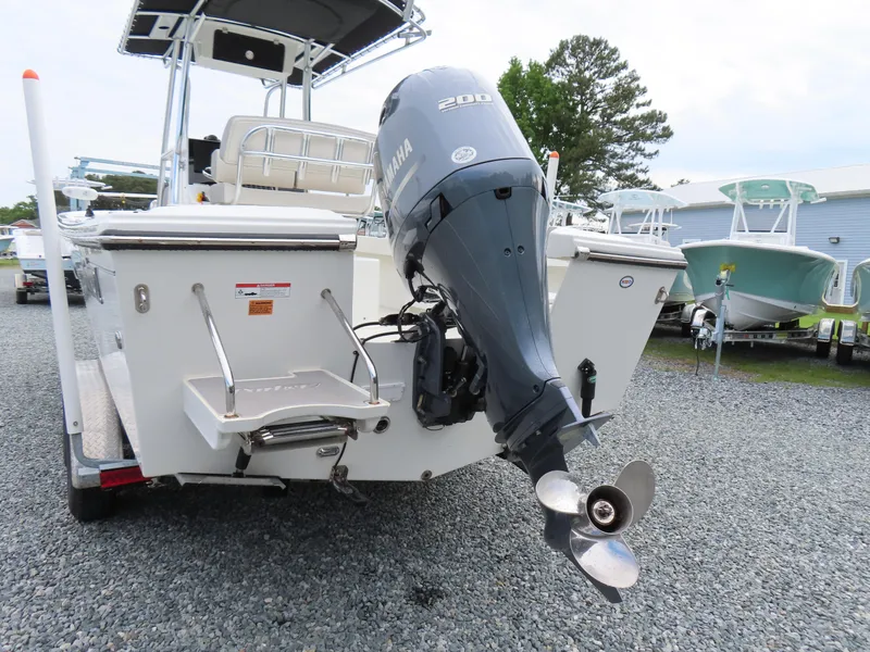 Slide: The Image of 2021 Parker 2300 Special Edition boat with Yamaha 200 engine, parked on gravel. - 4