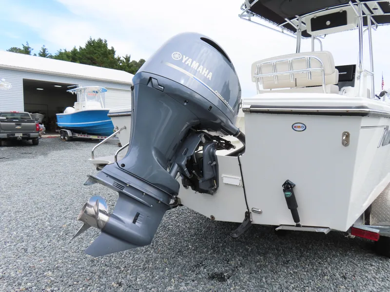 Slide: The Image of 2021 Parker 2300 Special Edition boat with Yamaha outboard motor in a marina setting. - 5