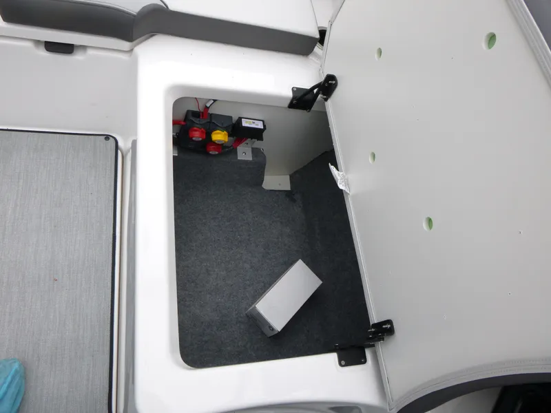 Slide: The Image of Open storage compartment in 2025 Yamaha Boats AR250, showcasing interior space and components. - 10