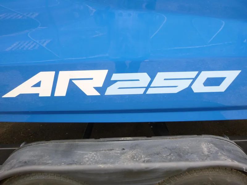 Slide: The Image of 2025 Yamaha Boats AR250, blue hull with bold white lettering. - 14