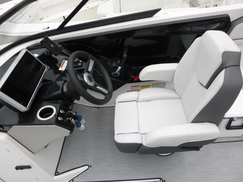 Slide: The Image of 2025 Yamaha Boats AR250 cockpit with modern steering and white captain's chair. - 4