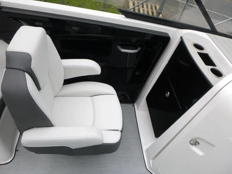 Slide: The Image of 2025 Yamaha Boats AR250 interior with white captain's chair and sleek black console. - 6