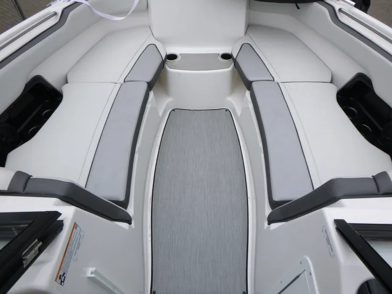 Slide: The Image of 2025 Yamaha Boats AR250 interior with gray seating and cup holders. - 7