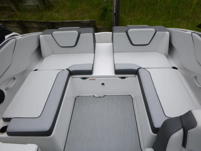 Slide: The Image of 2025 Yamaha Boats AR250 interior seating with gray and white upholstery. - 8