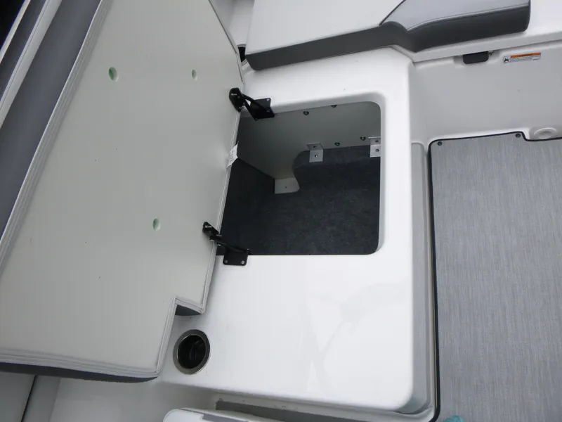 Slide: The Image of Open storage compartment on 2025 Yamaha Boats AR250 deck. - 9