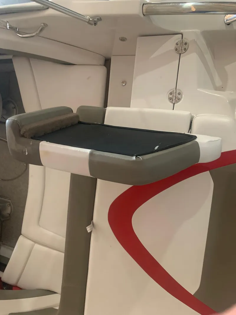 Slide: The Image of 2012 Glastron GLS 195 boat interior with cushioned seating and storage compartment. - 11