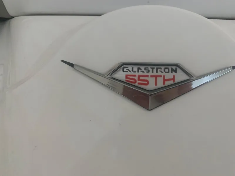 Slide: The Image of 2012 Glastron GLS 195 emblem with "55th" anniversary badge on white surface. - 13
