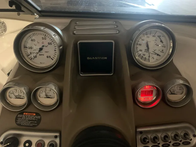 Slide: The Image of Dashboard of a 2012 Glastron GLS 195 boat with gauges and controls. - 18