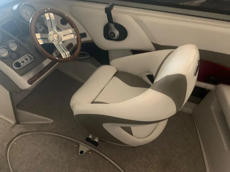 Slide: The Image of Interior of a 2012 Glastron GLS 195 boat with steering wheel and captain's chair. - 20