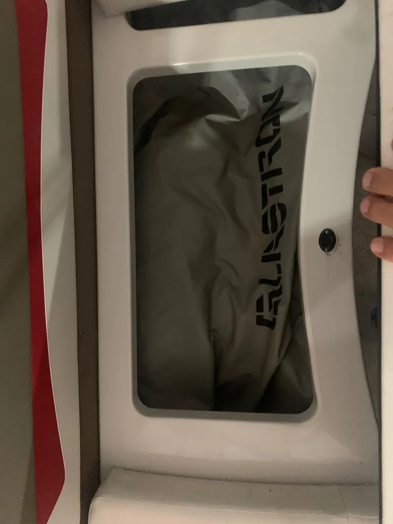 Slide: The Image of 2012 Glastron GLS 195 boat compartment with branded cover visible. - 22