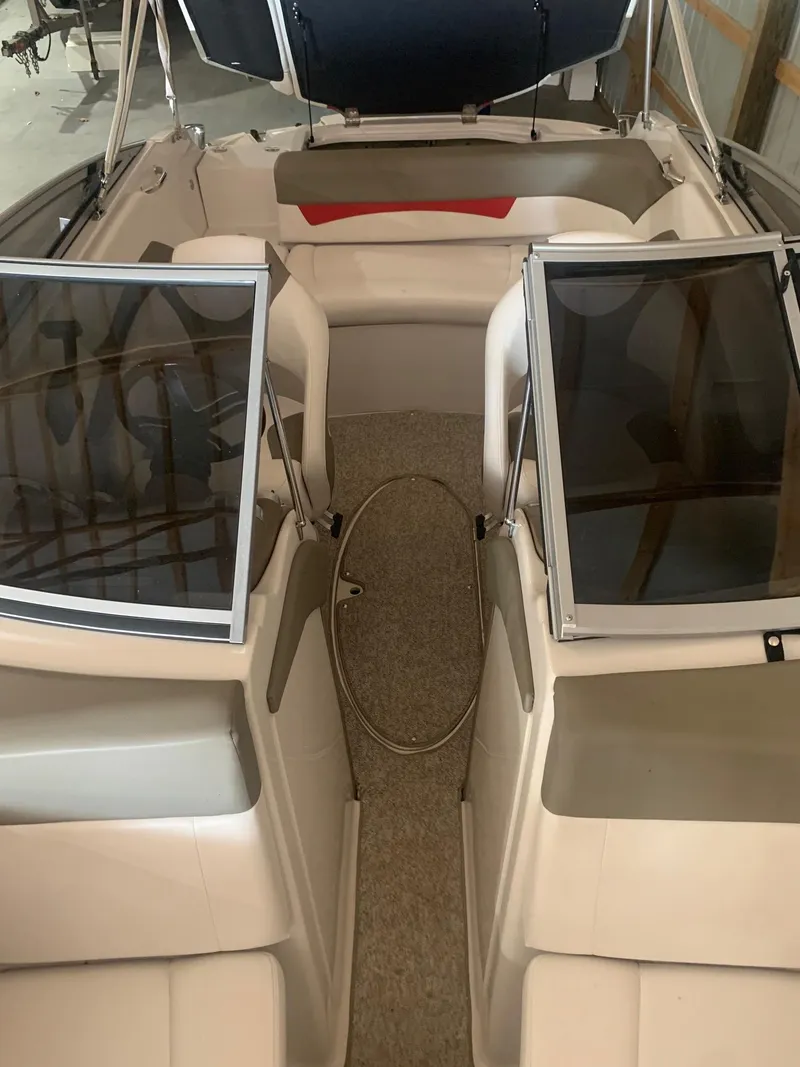 Slide: The Image of 2012 Glastron GLS 195 boat interior with open windshield and seating area. - 26