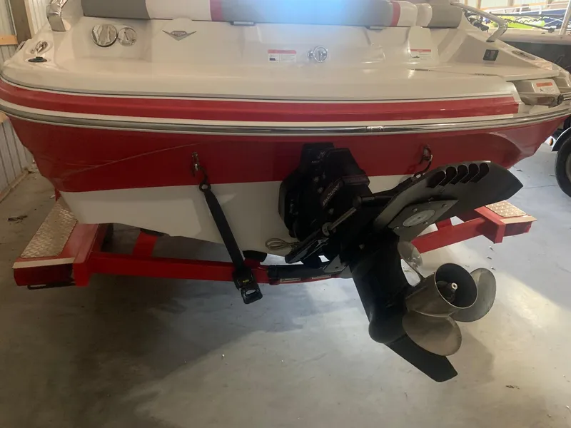 Slide: The Image of 2012 Glastron GLS 195 boat, red and white, rear view with propeller, in storage. - 9