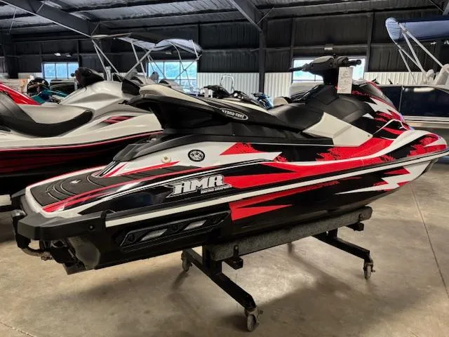 Slide: The Image of 2017 Yamaha WaveRunner EX with red and black design in a showroom. - 7