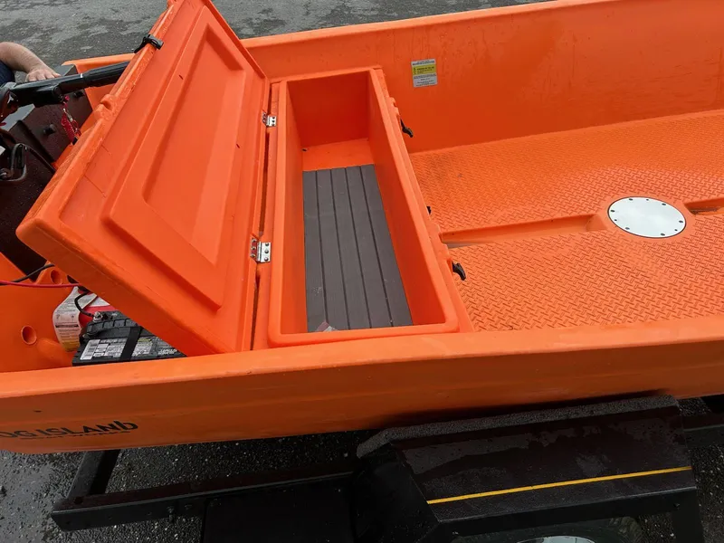 Slide: The Image of 2024 Hog Island Boat Works SW16, orange interior, open storage compartment, on trailer. - 6