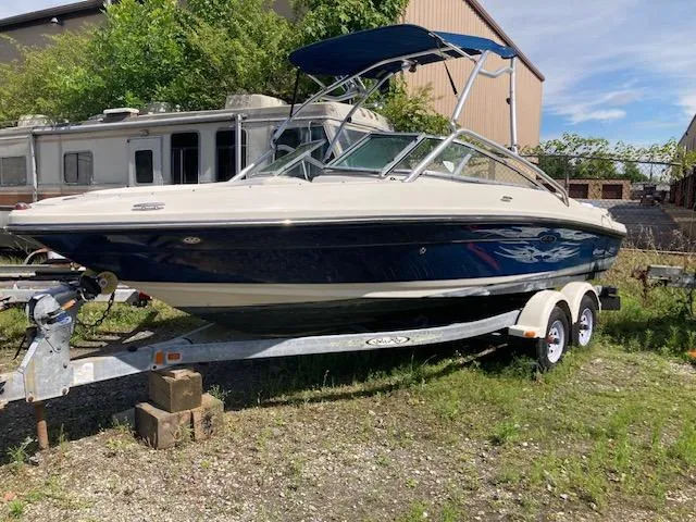 The Image of 2008 Sea Ray 205 Bow Rider boat on trailer, parked outdoors. - 0