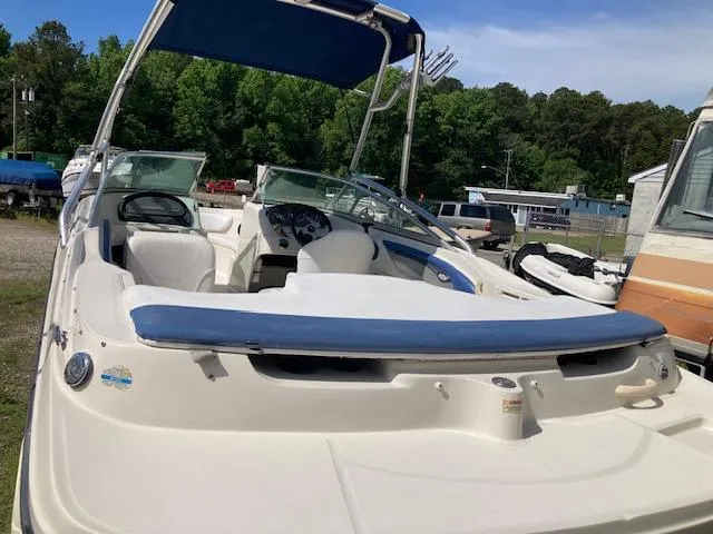 Slide: The Image of 2008 Sea Ray 205 Bow Rider boat with blue canopy, parked outdoors. - 8