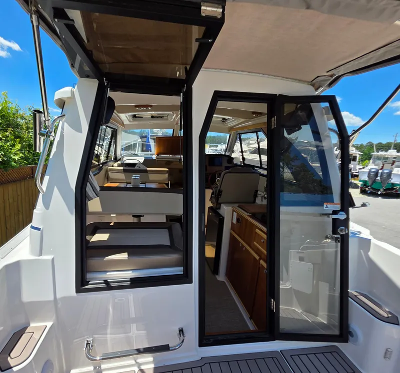 Slide: The Image of 2024 Cutwater C-248 Coupe interior view with open doors and seating area. - 5