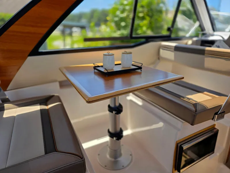 Slide: The Image of 2024 Cutwater C-248 Coupe interior with dining table and seating, featuring modern design elements. - 7
