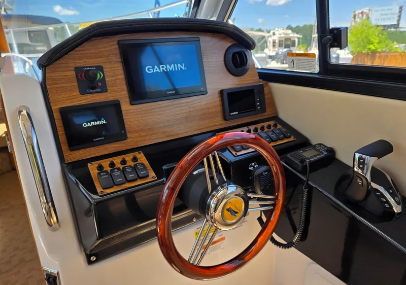 Slide: The Image of 2024 Cutwater C-248 Coupe helm with Garmin navigation system and wooden steering wheel. - 8