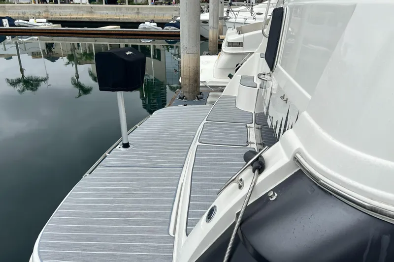Slide: The Image of 1995 Cruisers Yachts 3650 ACMY docked, showcasing sleek deck design and marina setting. - 13