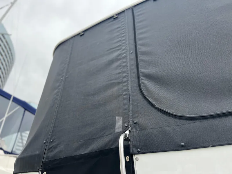 Slide: The Image of 1995 Cruisers Yachts 3650 ACMY with black canvas cover, close-up view. - 19