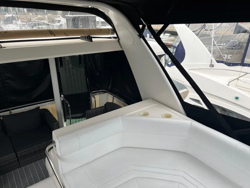 Slide: The Image of 1995 Cruisers Yachts 3650 ACMY with white seating and sleek design in marina setting. - 20