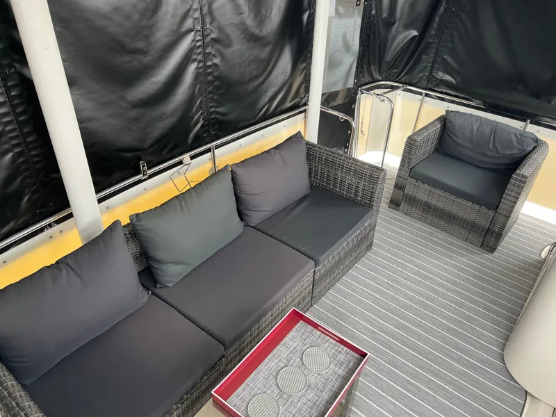 Slide: The Image of 1995 Cruisers Yachts 3650 ACMY interior with wicker seating and striped carpet. - 23