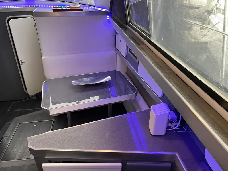 Slide: The Image of Interior of 1995 Cruisers Yachts 3650 ACMY with modern seating and ambient lighting. - 40