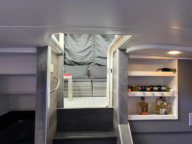 Slide: The Image of Interior of 1995 Cruisers Yachts 3650 ACMY with modern decor and built-in shelves. - 43