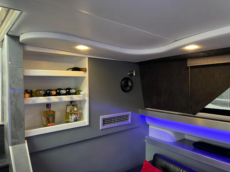 Slide: The Image of Interior of 1995 Cruisers Yachts 3650 ACMY with shelves and ambient lighting. - 44
