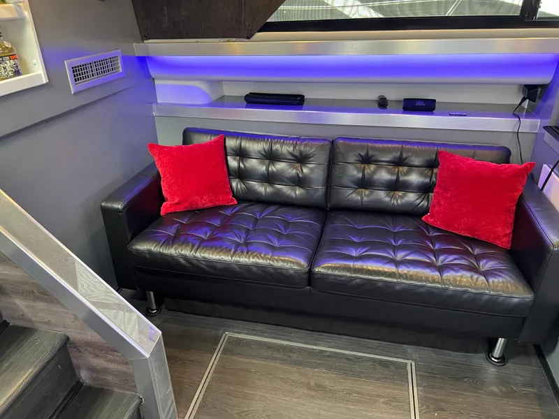 Slide: The Image of Luxurious 1995 Cruisers Yachts 3650 ACMY interior with black leather sofa and red cushions. - 46