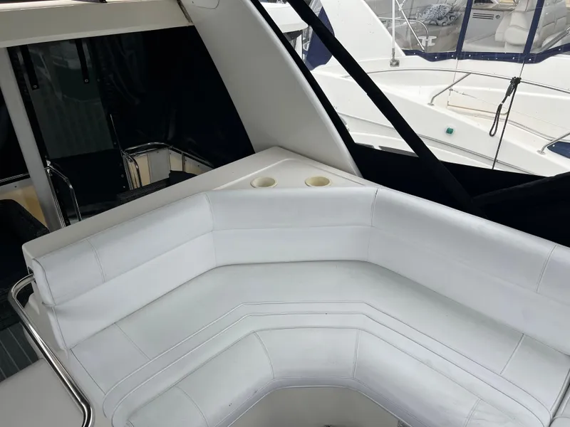 Slide: The Image of 1995 Cruisers Yachts 3650 ACMY interior with white seating and cup holders. - 29