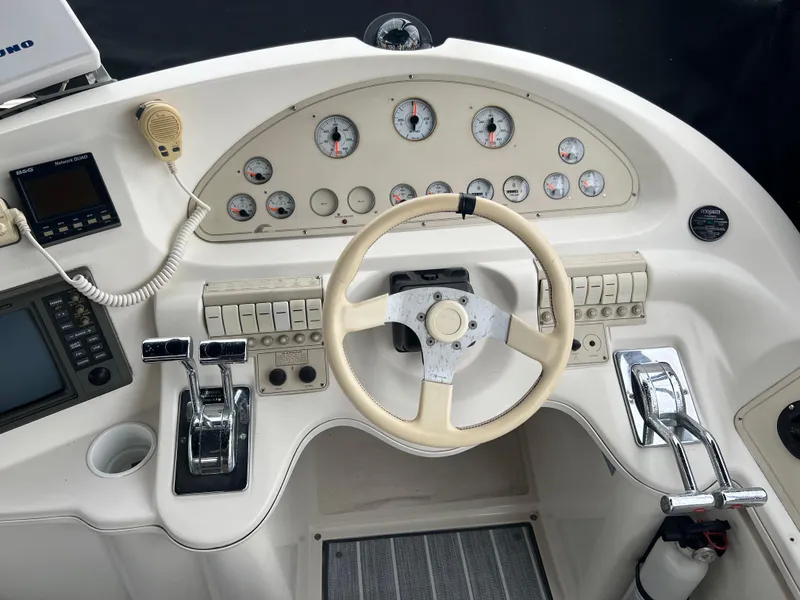 Slide: The Image of 1995 Cruisers Yachts 3650 ACMY helm with steering wheel and control panel. - 32