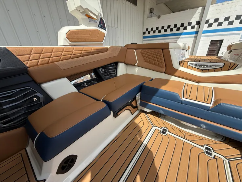 Slide: The Image of 2024 Nautique G21 interior with luxurious brown and blue seating, modern design, and premium finishes. - 15
