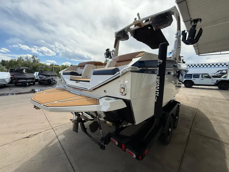 Slide: The Image of 2024 Nautique G21 boat on trailer, rear view, showcasing deck and seating. - 5
